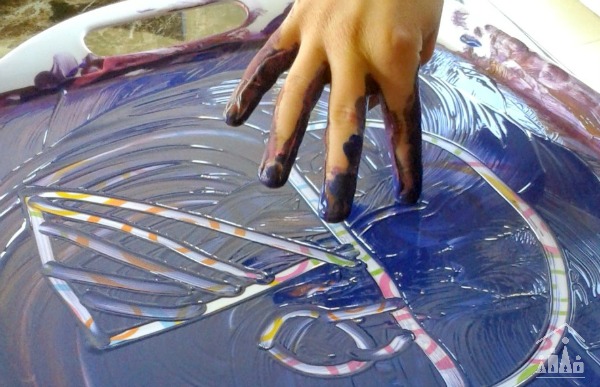 Child finger painting a boat