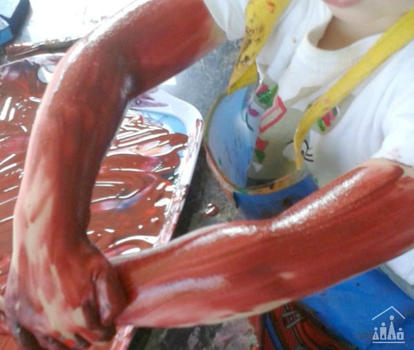 Child's arms covered in paint
