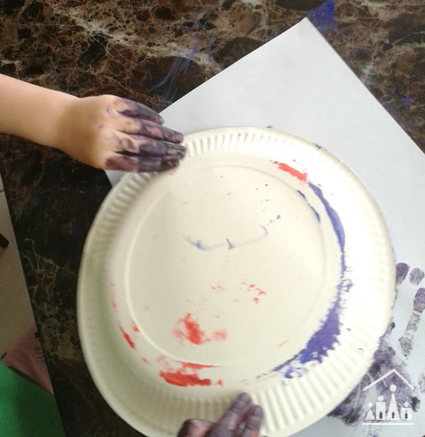 tape resist sponge painting for preschoolers getting messy