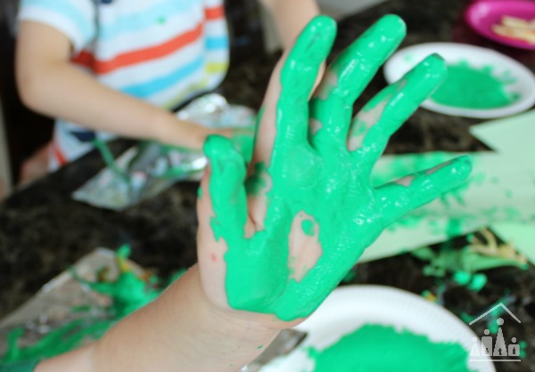 Dinosaur Stomp painting messy green hands