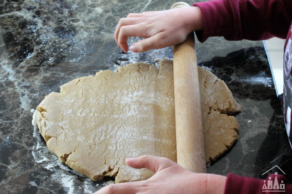 Child rolling out cookie dough