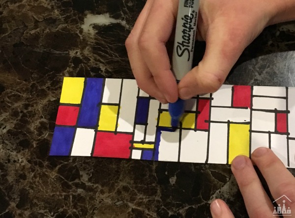Child making a bookmark in the style of famous artist Piet Mondrian