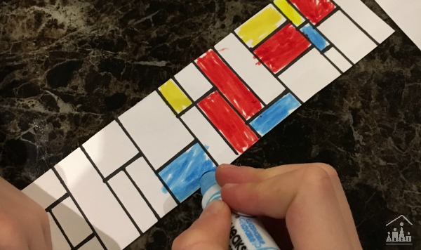 Child making a bookmark in the style of famous artist Piet Mondrian