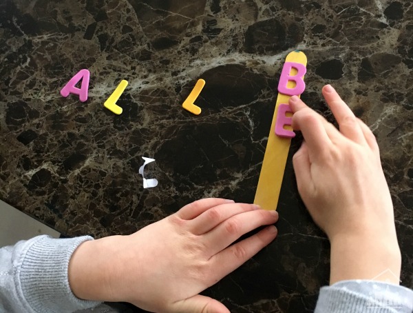 Child making a DIY Word Wand Kids Literacy Aid