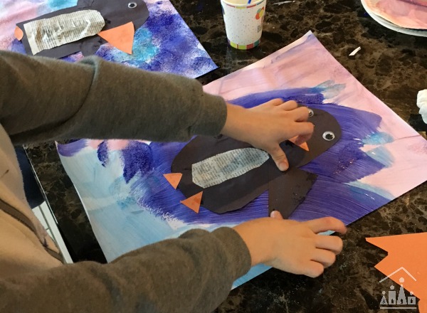 Child making a Winter Penguin Art Project 