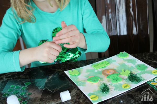 Adding glitter to a St Patrick's Day Collage